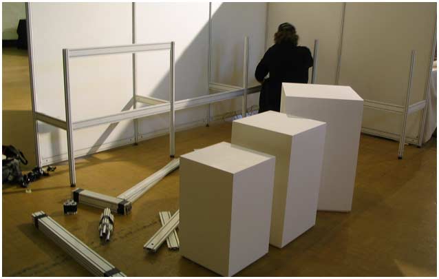 Stewart Contract Services installing a temporary exhibition wall, stands and plinths.